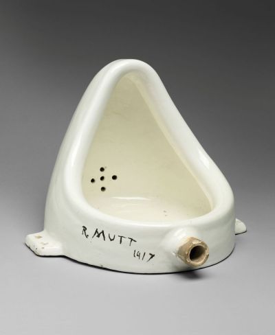 A urinal turned on its side with the words 'R. MUTT 1917' scrawled onto it.