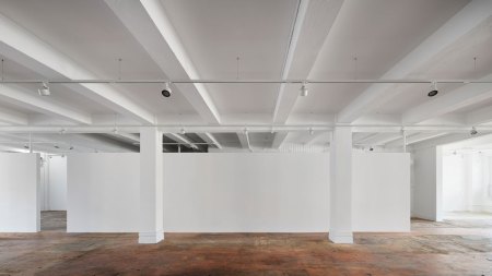View of an empty gallery with hardwood floors.