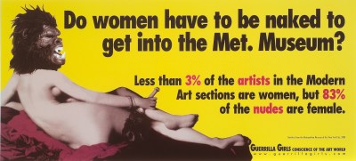 The image of a reclining light skinned nude woman seen from behind wearing a gorilla mask. Against a bright yellow background, large black text reads, “Do women have to be naked to get into the Met. Museum?” Smaller black and red text reads, “Less than 3% of artists in the Modern Art sections are women, but 83% of the nudes are female.”
