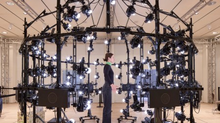 A woman standing in a full-body scanner.