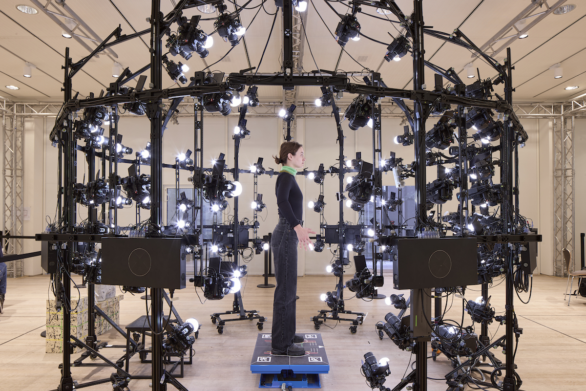 A woman standing in a full-body scanner.