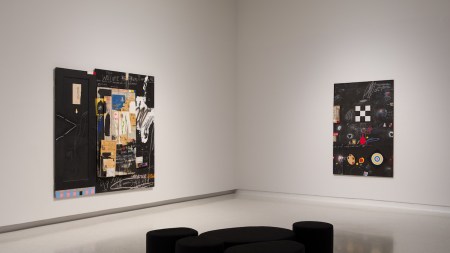 A gallery with two abstract paintings.