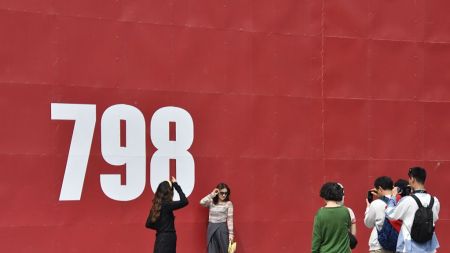 People pose for a photo at the 798 art zone in Beijing, capital of China, May 4, 2025. People across China enjoy the ongoing May Day holiday in various ways. (Photo by Li Xin/Xinhua via Getty Images)