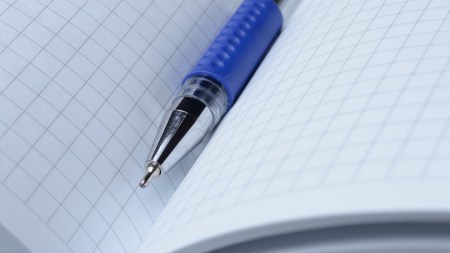 the gel pen lies on an open notebook. close-up.