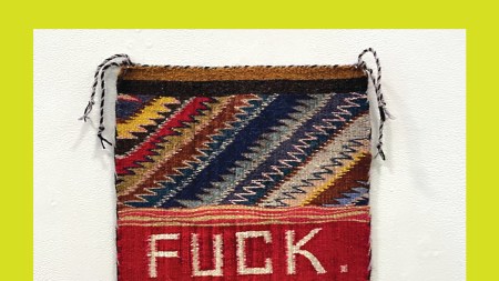 A woven textile rug with text reading "FUCK."