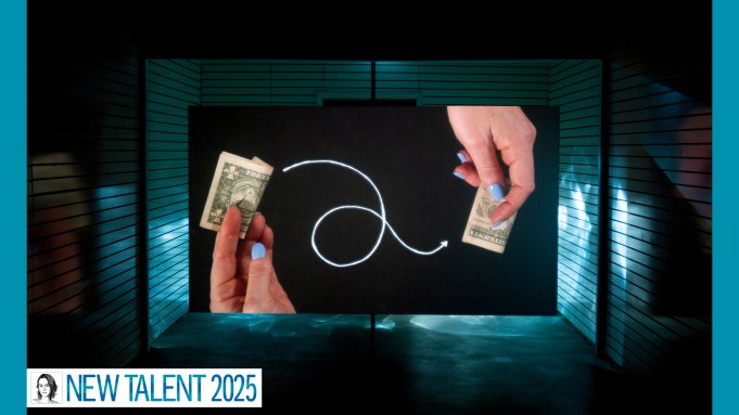 On a screen in a dark space, two light-skinned hands with periwinkle nails hold money; a drawn looping white arrow connects them.