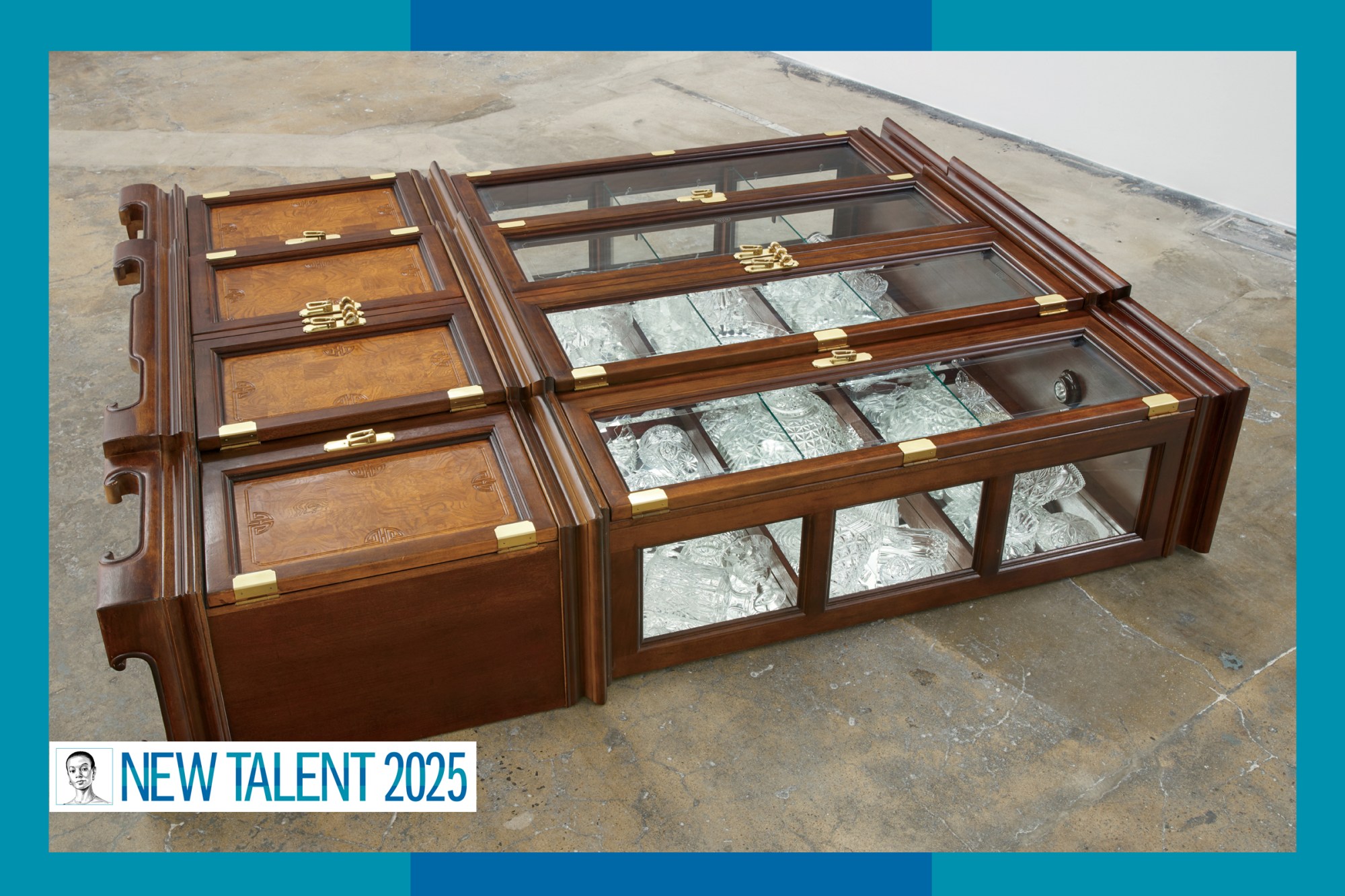 An ornate wooden china cabinet lays on the ground.