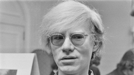 A white man in tinted glasses with wispy hair whose mouth hangs open slightly.