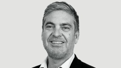 Black-and-white portrait of a white man with scruff in a suit