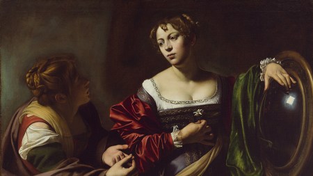 A dramatically lit baroque painting of two women. The central glowing figure holds a white flower to her chest and restes her hand on a reflective convex lens.