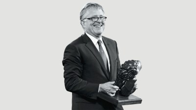 Black-and-white portrait of white man with a sculpture.