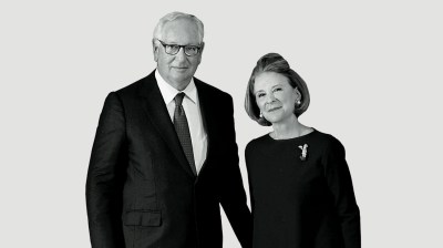 Black-and-white portrait of a tall elderly white man and a middle-aged Latin American woman