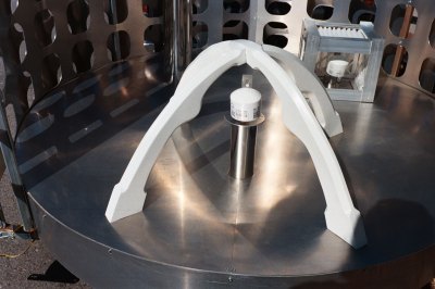 A sensor mounted on a circular metal platform is surrounded by a Space Age structure. 