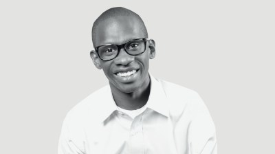 Black-and-white portrait of a middle-aged Black man with glasses