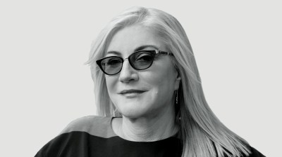 Black-and-white portrait of a white woman with glasses on