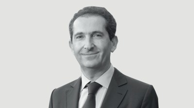 Black-and-white portrait of a young-looking middle-aged man in a suit