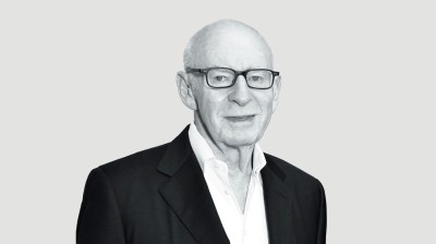 Black-and-white portrait of an older white man with glasses
