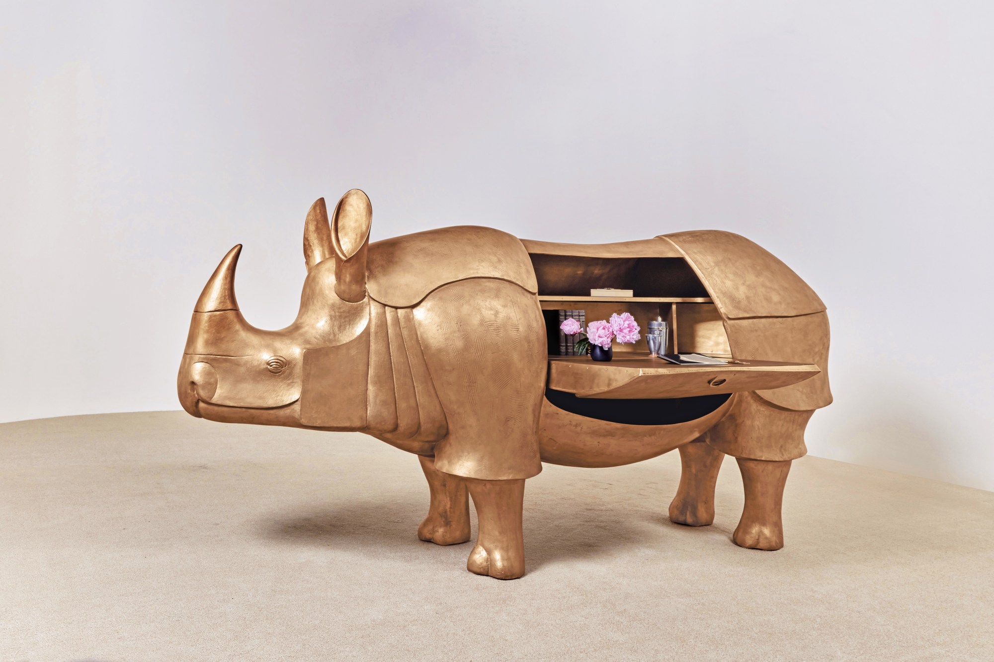 François-Xavier Lalanne's Grand Rhinocéros II (2003), a life-size sculptural gold patinated bronze, brass and leather desk in the shape of the animal. Image courtesy of Sotheby's.