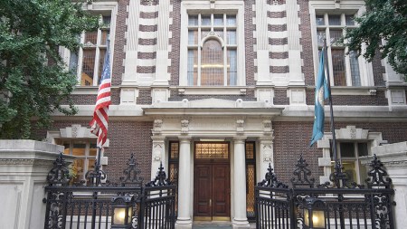 A collegiate Philadelphia building with an American and a Pennsylvania flag in front