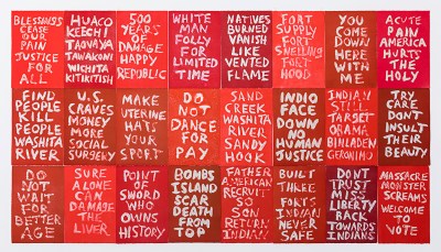 Red signs with white painted text, some of which is hard to read and in languages other than English. Examples include Bombs island scar death. from top, point of sword who owns history