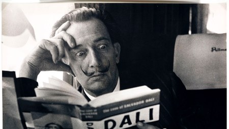 Salvador Dalí reading Fleur Cowles’s authorized biography of him, The Case of Salvador Dalí (1959), England, 6 May 1959.