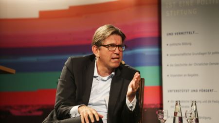 A man in glasses and a suit.