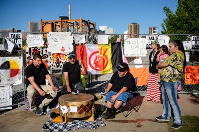 Members of the Dakota Sioux tribe hold a drum ceremony in front of Sam Durant’s Scaffold (2012), Minneapolis Sculpture Garden