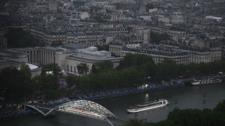 PARIS, FRANCE - JULY 26:  A boat with members of Brazil's delegation sails past the Passerelle Debilly bridge on the River Seine with the Musée d'Art Moderne de Paris in the background during the Opening Ceremony of the Olympic Games Paris 2024 on July 26, 2024 in Paris, France. (Photo by Luis ROBAYO - Pool/Getty Images)