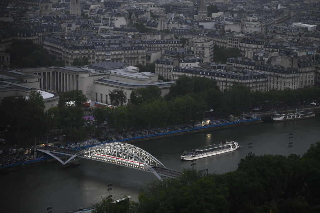 PARIS, FRANCE - JULY 26:  A boat with members of Brazil's delegation sails past the Passerelle Debilly bridge on the River Seine with the Musée d'Art Moderne de Paris in the background during the Opening Ceremony of the Olympic Games Paris 2024 on July 26, 2024 in Paris, France. (Photo by Luis ROBAYO - Pool/Getty Images)
