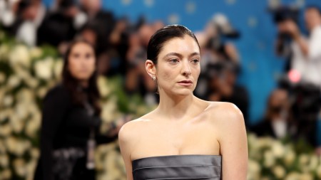 A woman wearing grey fabric over her breasts.