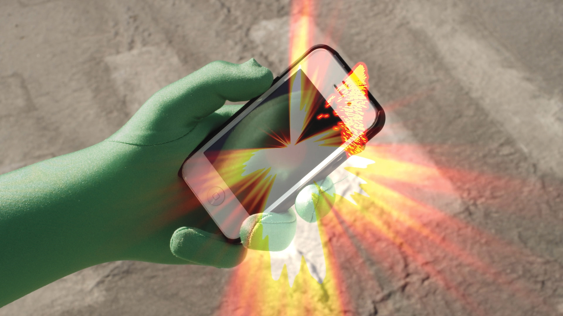 A hand in a green glove holds an iphone. An orange burst radiates from the phone's center. A crosswalk is visible in the background.