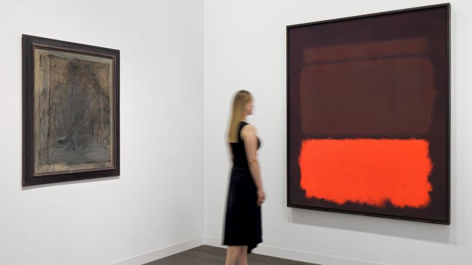A woman looks at an abstract color field painting by Rothko at right. At left is a muddied painted portrait of a man by Giacometti.