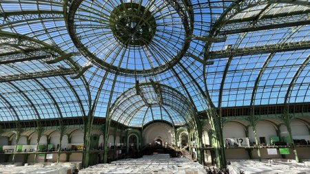 A glass-domed building with fair booths inside it.