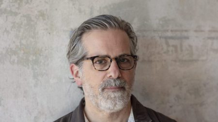 A white man in glasses with graying hair and beard.