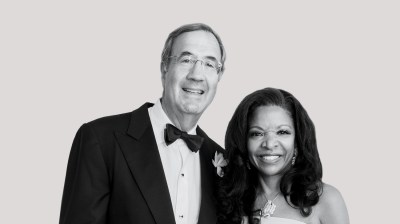 Black-and-white portrait of a middle-aged white man in a tux and a middle-aged Black woman in a dress