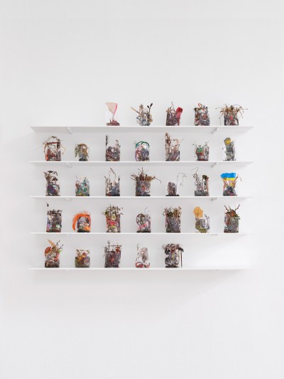 A group of shelves lined with cellophane containers holding trash.