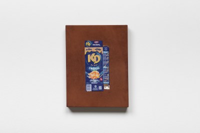 A beaded wall work that resembles a box of macaroni & cheese.