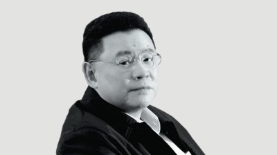Black-and-white portrait of a middle-aged Asian man with glasses