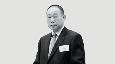 Black-and-white portrait of an older Asian man