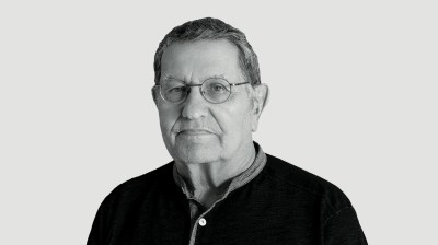 Black-and-white portrait of an older white man with glasses