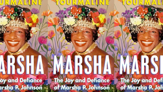 A book cover shows a picture of Marsha P. Johnson, a Black trans woman, smiling big with a crown of flowers and in a field of flowers.