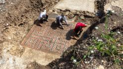 Archaeologists cleaning the mosaic outside of Alès, France.