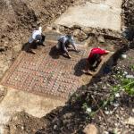 Archaeologists cleaning the mosaic outside of Alès, France.
