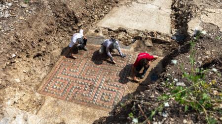 Archaeologists cleaning the mosaic outside of Alès, France.