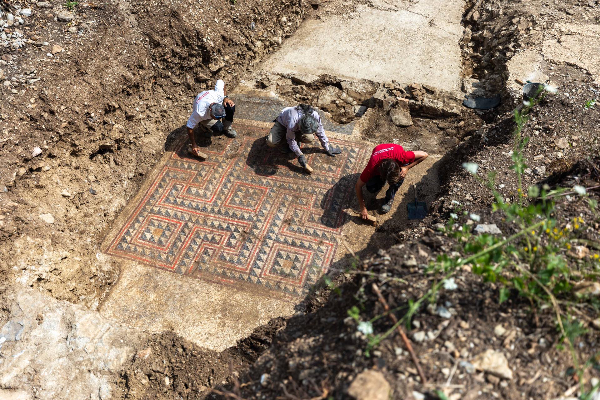 Archaeologists cleaning the mosaic outside of Alès, France.