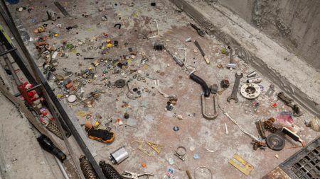An array of tools on a dirty floor.