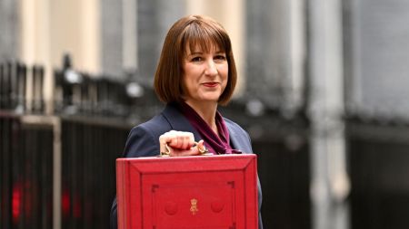 LONDON, ENGLAND - OCTOBER 30: Chancellor of the Exchequer, Rachel Reeves, poses with the red Budget Box as she leaves 11 Downing Street to present the government's annual budget to Parliament on October 30, 2024 in London, England. This is the first Budget presented by the new Labour government and Chancellor of the Exchequer, Rachel Reeves. (Photo by Leon Neal/Getty Images)