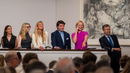 four smiling women and two smiling men in a row.