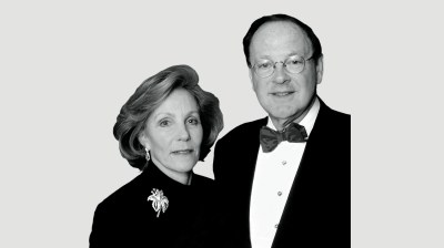 Black-and-white portrait of a middle-aged white woman and man in formalwear