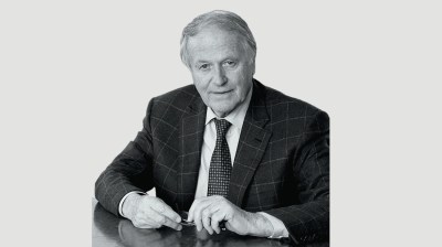 Black-and-white portrait of an older white man in a suit